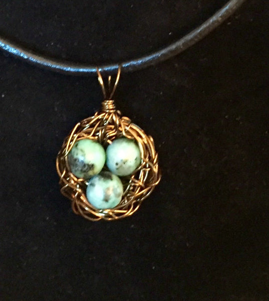 Necklace, birds nest pendant, bronze antique wire, three Turquoise eggs, handmade, on simple leather necklace