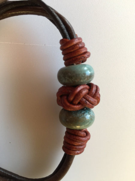 Leather bracelet, with turks head endless knot and green ceramic.